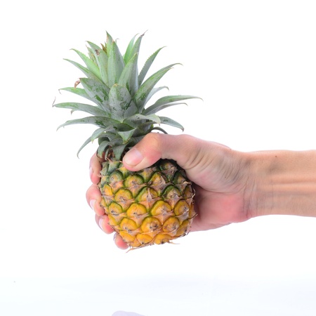 Pineapple holding by man's hand, on white backgroundの写真素材