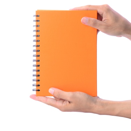 Blank orange notebook, with ring spiral, showing by man's hands isolated on whiteの写真素材
