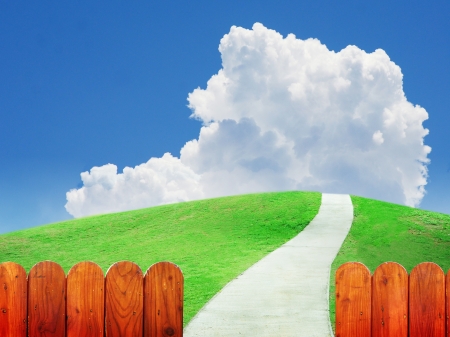 Buautiful green field and tranquil scene on white cloud, blue sky, view over vintage wooden fenceの写真素材