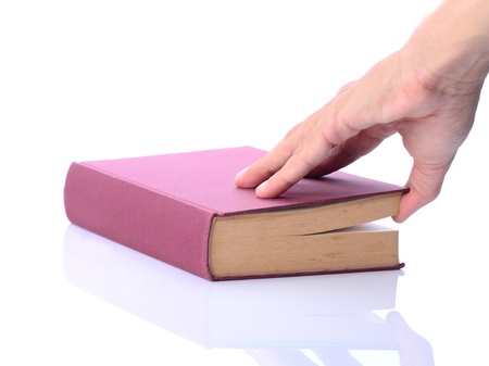Man's hand opening thick red book, on white backgroundの写真素材