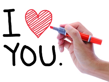 Man's hand writing and drawing heart shape in wording, I love you.の写真素材