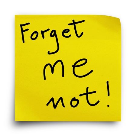 Yellow sticker paper note on white background with wording, forget me not!の写真素材