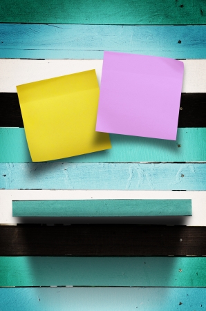 Sticker paper note on vintage blue wood wall panel with shelfの写真素材