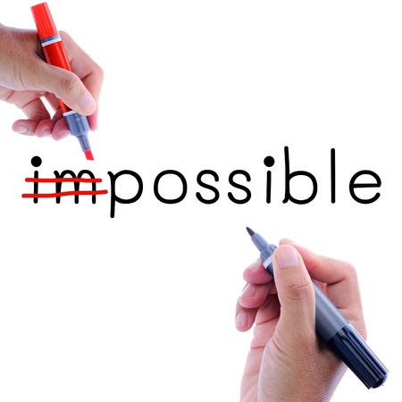 Man hand writing possible from impossible. Motivation conceptの写真素材