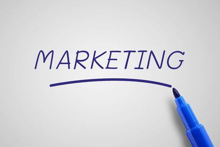 Blue pen marker with word marketing, business concept in marketing concept, gray background.の写真素材