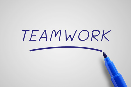 Blue pen marker with word teamwork, business concept in team work concept, gray background.の写真素材