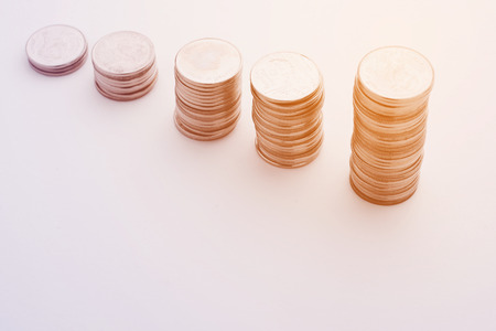 Growth of stacked money coins, abstract background business concept in growing up economy.の写真素材