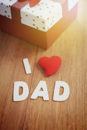 Letter make word I love DAD with heart shape symbol and gift box, celebration Happy Father's day concept. Wood background, vintage style.の写真素材