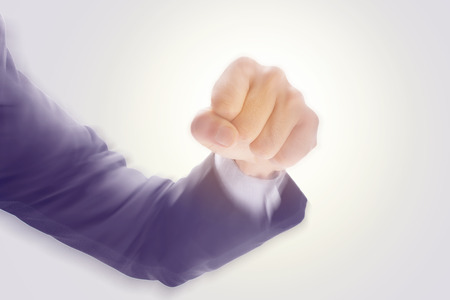 Business man's hand hold fist and punch, isolated on white background, motion radial blur effect, business concept in fight or strength. の写真素材
