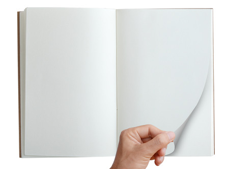 Hand pick and open page of notebook isolated on white, top view.の写真素材