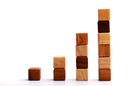 Stack of square wood block in statistics graph shape, metaphor to business keep growing and rising. Empty and blank space for your text, design or copyspace. の写真素材