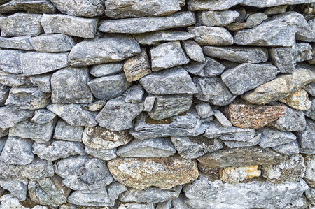 Rural fence made with grey stone masonryの写真素材