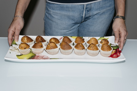Woman with homen made muffinsの写真素材