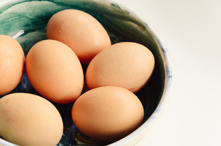 Fresh eggs an virgin olive oil on a kitchen table