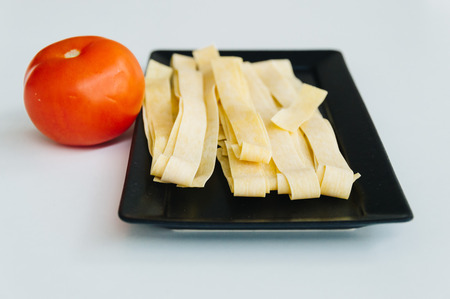 Fresh pasta and tomato on white backgroundの写真素材