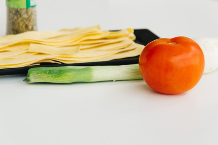 Fresh pasta and vegetables on white backgroundの写真素材