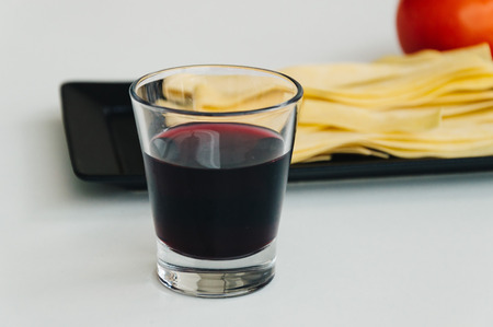 Fresh pasta, red wine and tomato on white backgroundの写真素材