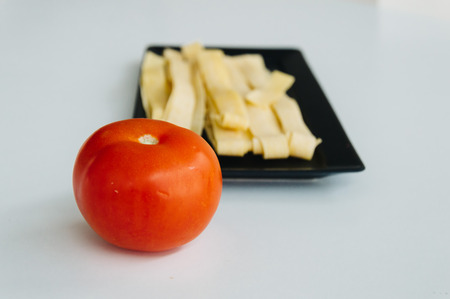 Fresh pasta and tomato on white backgroundの写真素材