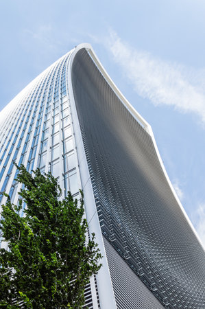 LONDON, UK - AUGUST 21, 2015: Modern office building in London designed by Vinoli architects. Low angle view against a blue sky dayのeditorial素材