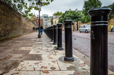 LONDON, UK - AUGUST 24, 2015: Row of bollards in a street of London, low angle view on a cloudy dayのeditorial素材
