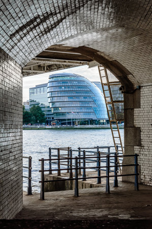 LONDON, UK - AUGUST 21, 2015: London City Hall framed by the archs of Tower Bridge. The City Hall was designed by Norman Foster.のeditorial素材