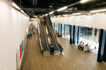 LONDON, UK - AUGUST 22, 2015: High angle view of escalators in Tate Modern Art Gallery interior. With people blurred movingのeditorial素材