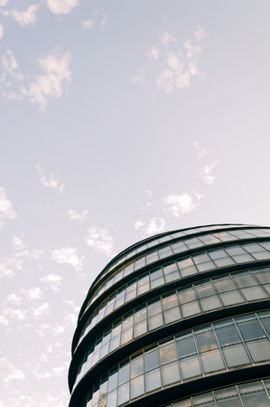 LONDON, UK - AUGUST 21, 2015: Modern office building. Clouds reflections on the glass and detail of a curtain wall. Designed by Norman Fosterのeditorial素材