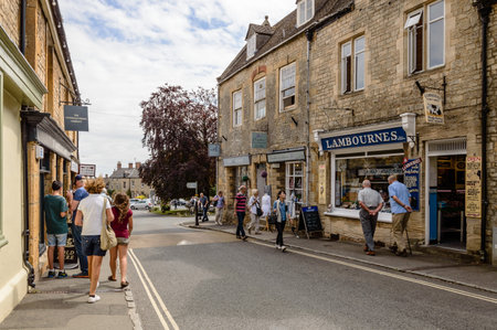 STOW-ON-THE-WOLD, UK - AUGUST 12, 2015:  Commercial street with tourists in Stow on the Wold. Stow...