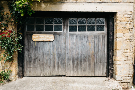 STOW-ON-THE-WOLD, UK - AUGUST 12, 2015:  Park garage wooden door decorated with green  natural plants.のeditorial素材