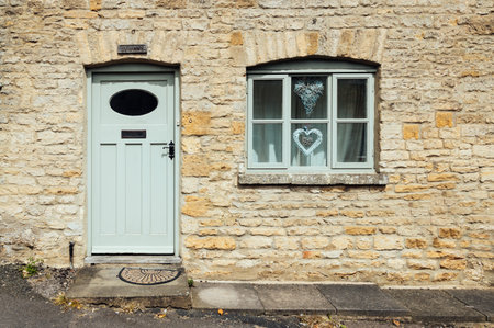 STOW-ON-THE-WOLD, UK - AUGUST 12, 2015:  Limestone cottage entrance. Painted wooden  door and window.のeditorial素材