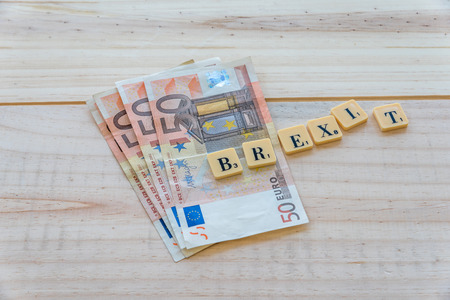 Brexit text with euro money on wooden background. The United Kingdom European Union membership referendum on 23 June 2016の写真素材