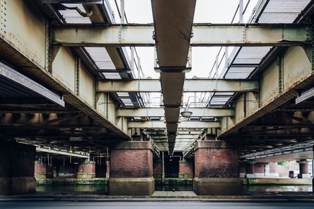 Under and old steel  Railroad bridge in the city of Amsterdamの写真素材