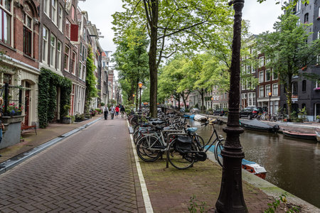 Amsterdam, Netherlands - August 2, 2016: Street in historical city center of Amsterdam. It is one of the most romantic and beautiful cities in Europe.  Amsterdam is also a city of tolerance and diversity.のeditorial素材
