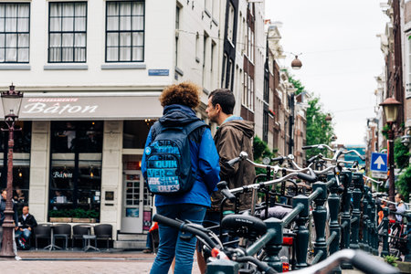 Amsterdam, Netherlands - August 2, 2016: Travelers in the street in historical city center of Amsterdam. It is one of the most romantic and beautiful cities in Europe.  Amsterdam is also a city of tolerance and diversity.のeditorial素材
