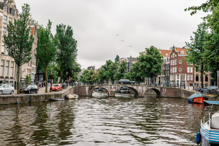 Amsterdam, Netherlands - August 2, 2016: Street in historical city center of Amsterdam. It is one of the most romantic and beautiful cities in Europe.  Amsterdam is also a city of tolerance and diversity.のeditorial素材