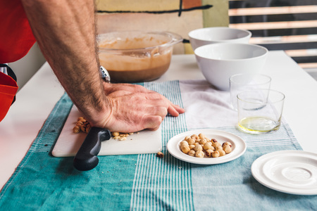 Man preparing a homemade cake with chocolate and hazelnutsの写真素材