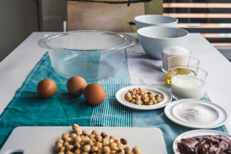 Ingredients for baking sweet cake with chocolate and hazelnuts, side view