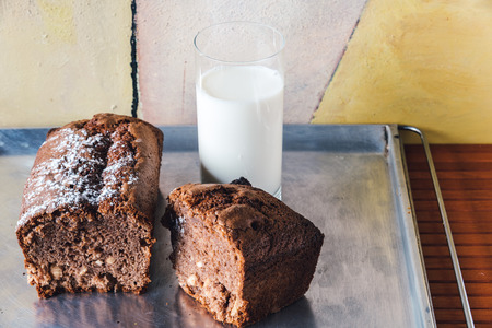 Chocolate cake with a glass of milk on baking tray