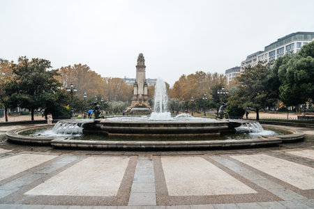 Madrid, Spain - November 20, 2016: Rainy day in Spain Square of Madrid. Fountain and Cervantes monument on backgroundのeditorial素材