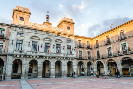 Avila, Spain - November 11, 2014:  People in Town Hall square called Mercado Chico a cloudy day at sunset. The old city  and its extramural churches were declared a World Heritage site by UNESCOのeditorial素材