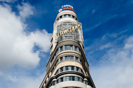 Madrid, Spain - September 18, 2016:   Low angle view of Capitol building at Gran Via Street in Madrid. It is an important street in Central Madrid with shops and theaters.のeditorial素材
