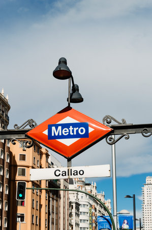 Madrid, Spain - September 18, 2016:  Madrid Metro sign at the entrance to Callao station at Gran Via Street in Madrid. Low angle view, vertical compositionのeditorial素材