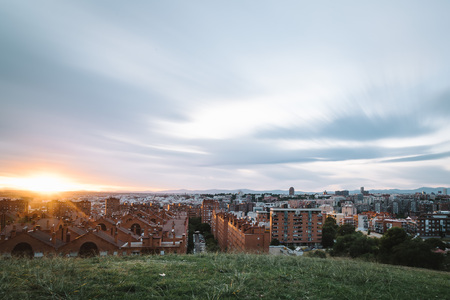 Madrid cityscape at dusk from a residential district and mountain range at backgroundの写真素材