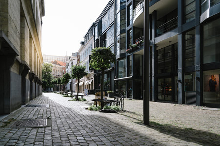Antwerp, Belgium - July 28, 2016:  Pedestrian street in Antwerp at sunset with sunlight on background. It is a city in Belgium in the region of Flanders. It has the biggest port in Belgium.のeditorial素材