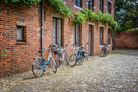 Leuven, Belgium - July 30, 2016:  The Grand Beguinage of Leuven, is a well preserved and completely restored historical quarter is owned by the University of Leuven and used as a campus. Bicycles parkedのeditorial素材