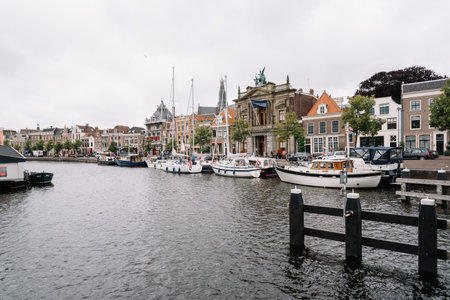 Haarlem, Netherlands - August 3, 2016: Picturesque cityscape with beautiful traditional houses and vessels in canal of Haarlemのeditorial素材