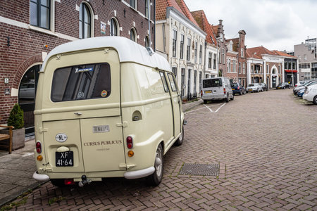 Haarlem, Netherlands - August 3, 2016: Picturesque street with beautiful traditional houses and retro van vehicle on foreground in Haarlemのeditorial素材
