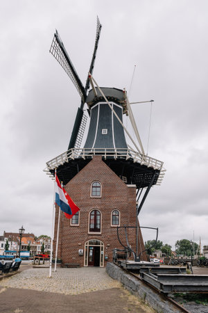 Haarlem, Netherlands - August 3, 2016: Picturesque cityscape with windmill in Haarlemのeditorial素材