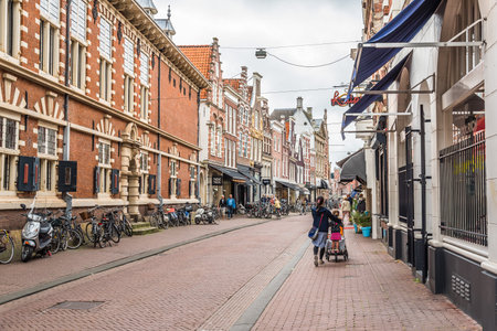 Haarlem, Netherlands - August 3, 2016: Picturesque commercial street of Haarlem near the cathedral, with bicycles and peopleのeditorial素材