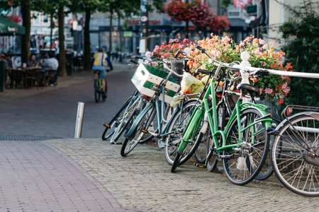 Delft, Netherlands - August 3, 2016: Bicycle parked on the bridge in a picturesque street in the...